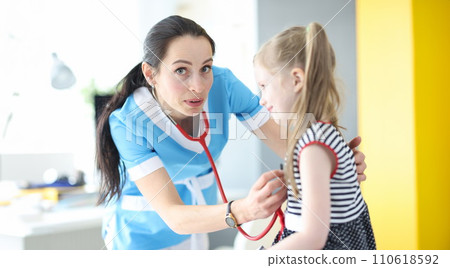 Doctor pediatrician forgot to put stethoscope in her ears. Doctor pediatrician forgot to put stethoscope in her ears. 110618592