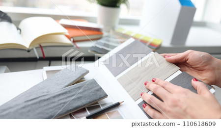Woman choosing color of laminate board in design studio closeup 110618609