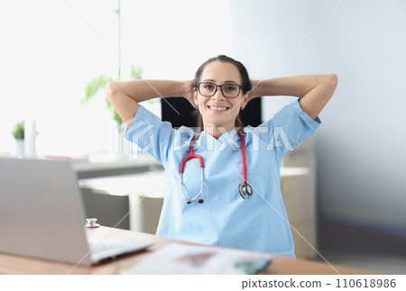 Portrait of smiling doctor at his work table 110618986