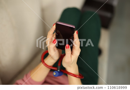 Female hands with lock hold smartphone closeup Female hands with lock hold smartphone closeup 110618999