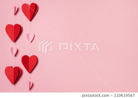 Paper garland from red and pink hearts On pink Background, copy space. Happy San Valentine Day. greeting card Paper garland from red and pink hearts On pink Background, copy space. Happy San Valentine Day. greeting card 110619567