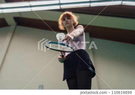 Indoor sports. People different ages play badminton on sports court indoors 110619899
