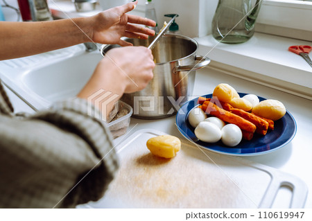 cutting boiled vegetables into Olivier salad 110619947