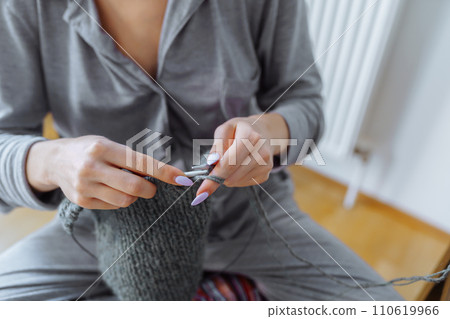 young woman knits wool product 110619966