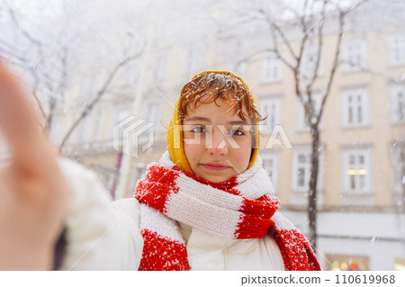 Positive portrait teenage girl in snowfall cityscape 110619968