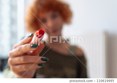 portrait red-haired attractive teenage girl with manicure and red lipstick portrait red-haired attractive teenage girl with manicure and red lipstick 110619995