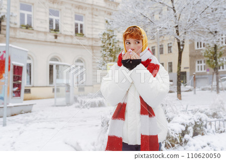 Positive portrait teenage girl in snowfall cityscape 110620050