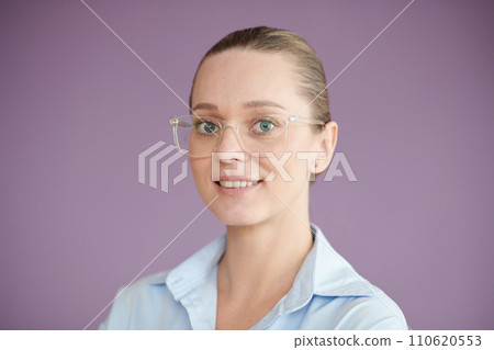 Portrait of positive entrepreneur in glasses standing against lilac background Portrait of positive entrepreneur in glasses standing against lilac background 110620553