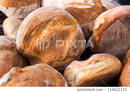 Ruddy rolls of fresh warm grain bread 110622135