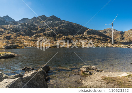 Wind turbine on a mountain lake at the Gotthard Pass, Canton of Ticino, Switzerland Wind turbine on a mountain lake at the Gotthard Pass, Canton of Ticino, Switzerland 110623332