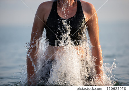 Jump out of the water with streaming splashes. 110623958