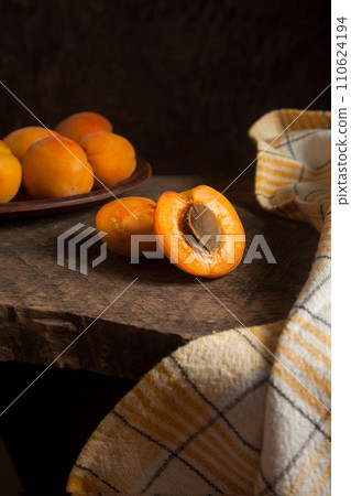Halves of apricot fruit  on wooden background.. 110624194
