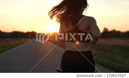 silhouette sports girl running legs along road sunset, sports track morning, jogging road, outdoor exercise, athlete exercise sunrise, running sportswear, confident motivated beautiful sportswoman 110624507