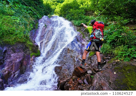 Climber looking at Banjo Falls on Mt. Sharidake 110624527