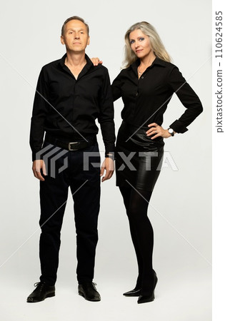 Portrait of a mature couple. Two elderly man and woman hugging in full length isolated on a gray background. 110624585