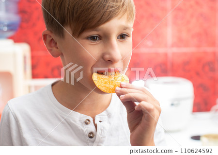 Boy eating chips close-up. Potato chip child. 110624592