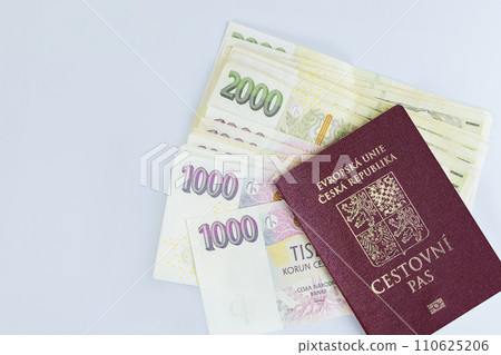 Passport Czech Republic are stacked along with banknotes various denominations of CZK koruna stacked on white background 110625206