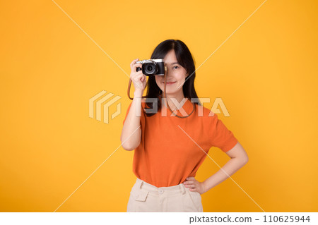 portrait cheerful young 30s asian woman happy smile with posing a camera isolated on yellow studio background. portrait cheerful young 30s asian woman happy smile with posing a camera isolated on yellow studio background. 110625944