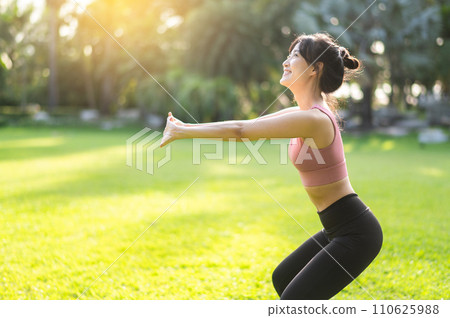 Embrace active and healthy lifestyle with fit young Asian woman 30s wearing pink sportswear engages in squat in public park, preparing for revitalizing run and embodying the wellness concept. Embrace active and healthy lifestyle with fit young Asian woman 30s wearing pink sportswear engages in squat in public park, preparing for revitalizing run and embodying the wellness concept. 110625988