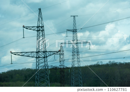 High voltage towers with sky background. Power line support with wires for electricity transmission. High voltage grid tower with wire cable at distribution station. Energy industry, energy saving High voltage towers with sky background. Power line support with wires for electricity transmission. High voltage grid tower with wire cable at distribution station. Energy industry, energy saving 110627781