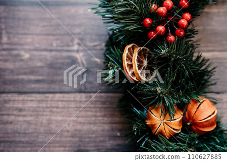 Banner with dried tangerines. Wooden background. Creating unique and eye-catching New Year decor festive atmosphere. Banner with dried tangerines. Wooden background. Creating unique and eye-catching New Year decor festive atmosphere. 110627885