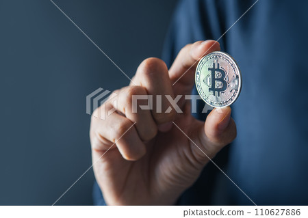 Bitcoin Blockchain Technology and Cryptocurrency. Hand holding bitcoin for Digital Finance and trading concept. Bitcoin Blockchain Technology and Cryptocurrency. Hand holding bitcoin for Digital Finance and trading concept. 110627886