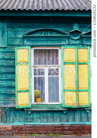Background of an old window with wooden shutters. Wall of a wooden house with a window. 110628132