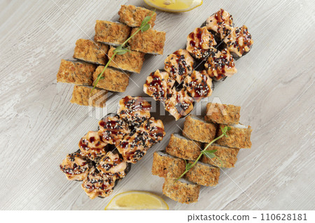 Set of various sushi rolls on a white wooden background close-up. 110628181