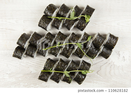 Set of various sushi rolls on a white wooden background close-up. Set of various sushi rolls on a white wooden background close-up. 110628182
