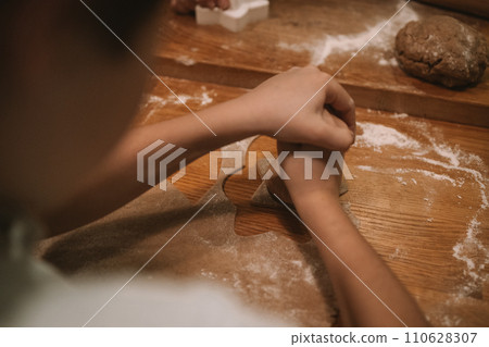 Process of making heart-shaped gingerbread for Christmas and New Year. Traditional festive food making, family culinary. Process of making heart-shaped gingerbread for Christmas and New Year. Traditional festive food making, family culinary. 110628307