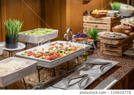 Catering meals prepared for guests at a wedding or hotel dinner. Healthy salads and other vegetables 110628778