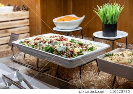 Catering meals prepared for guests at a wedding or hotel dinner. Healthy salads and other vegetables 110628780