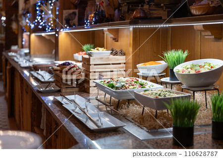 Buffet table full of dishes and salads ready for dinner for hotel guests 110628787