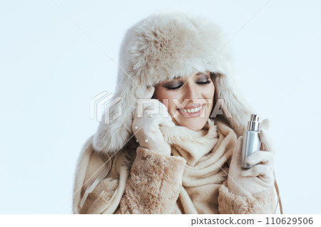 happy stylish woman in winter coat and fur hat on white happy stylish woman in winter coat and fur hat on white 110629506
