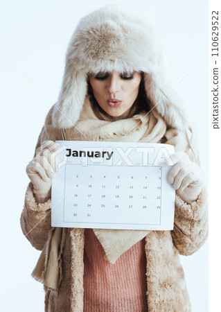 surprised modern woman in winter coat and fur hat on white surprised modern woman in winter coat and fur hat on white 110629522