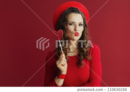 stylish woman against red background sending kiss stylish woman against red background sending kiss 110630288