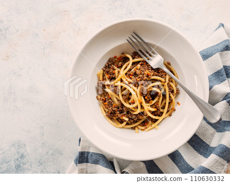 Spaghetti bolognese with minced meat or Makarony Po Flotski or Russian Navy Style Pasta. Top view. Navy spaghetti in plate, copy space. Spaghetti bolognese with minced meat or Makarony Po Flotski or Russian Navy Style Pasta. Top view. Navy spaghetti in plate, copy space. 110630332