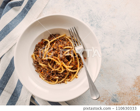 Spaghetti bolognese with minced meat or Makarony Po Flotski or Russian Navy Style Pasta. Top view. Navy spaghetti in plate, copy space. 110630333