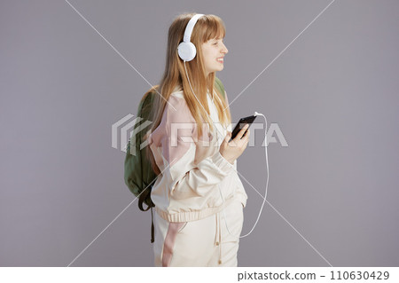happy teen girl listening to music and using phone happy teen girl listening to music and using phone 110630429