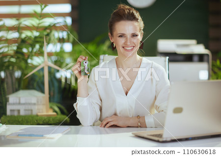 happy modern 40 years old woman realtor in modern green office 110630618