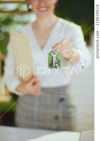 Closeup on young female realtor in modern green office Closeup on young female realtor in modern green office 110630619