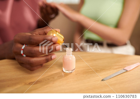 Hands of teenage girl doing manicure her best friend 110630783