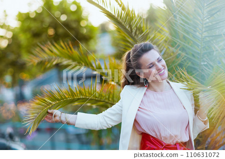 happy trendy 40 years old woman in dress and jacket in city happy trendy 40 years old woman in dress and jacket in city 110631072