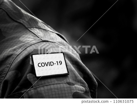 COVID-19 Inscription on military uniform. COVID-19 concept. Coronavirus war concept. Empty space for text COVID-19 Inscription on military uniform. COVID-19 concept. Coronavirus war concept. Empty space for text 110631075