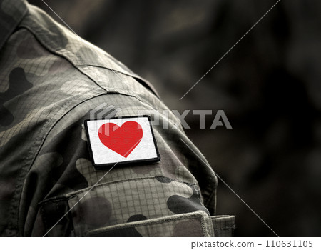 Red heart on military uniform. Love and war concept Red heart on military uniform. Love and war concept 110631105