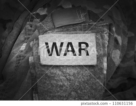Inscription WAR on military uniform. War concept. Inscription WAR on military uniform. War concept. 110631156