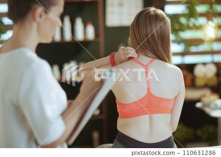 female therapist checking neck condition during examination female therapist checking neck condition during examination 110631286
