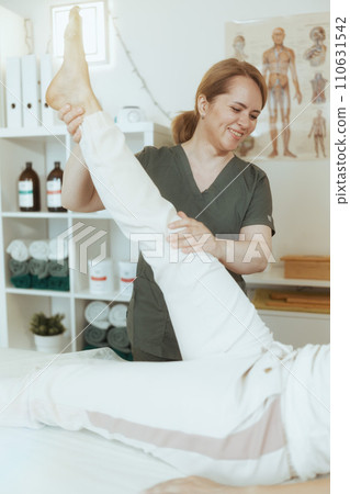 happy female therapist in massage cabinet doing checkup 110631542