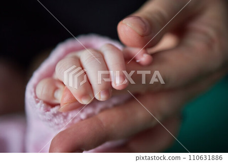 Parent hands holding newborn baby fingers, Close up mother's hand holding their new born baby. Love family healthcare and medical body part. 110631886