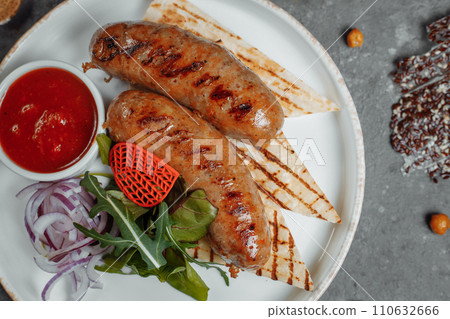 Grilled tasty bratwurst sausages on the plate 110632666